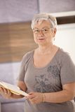 Senior teacher holding textbook Royalty Free Stock Photo