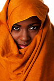 Mysterious female face in ocher head wrap Royalty Free Stock Photography