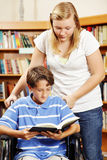 Teen Helps Younger Student Stock Photos