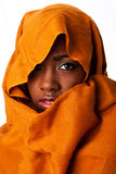 Mysterious female face in ocher head wrap Royalty Free Stock Images