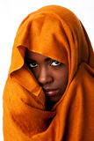 Mysterious female face in ocher head wrap Stock Image