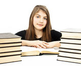 Young girl sitting at the desk and reading book Stock Photography