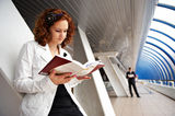 Girl student reading a textbook Stock Image