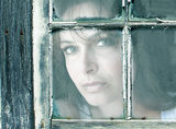 Woman in window Stock Images