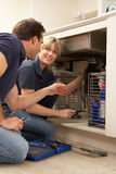 Plumber Teaching Apprentice To Fix Kitchen Sink Royalty Free Stock Photo