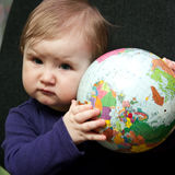 Baby girl with world globe Royalty Free Stock Photo
