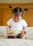 Baby with book Stock Images