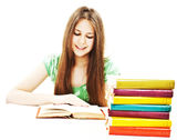 Young girl sitting at the desk and reading book Royalty Free Stock Photography