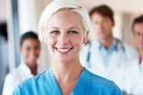 Young lady nurse and her team standing behind Stock Image