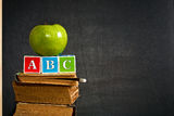 ABC and green apple on old textbook Stock Images