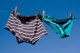 Gender concept mens cotton boxers & silk panties Stock Photography