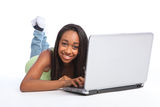Cute African teenager girl online using laptop Stock Photos