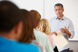 Tutor teaching class of students Stock Photo