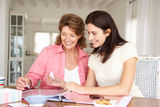 Happy adult mother and daughter scrapbooking Stock Images