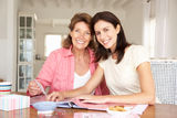 Adult mother and daughter scrapbooking Stock Photos
