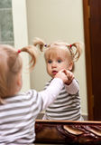 Girl and mirror Royalty Free Stock Image