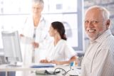 Elderly man waiting for examination smiling Stock Image