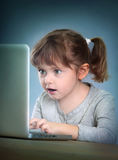 Little girl with laptop Royalty Free Stock Photo