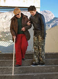 A teenager and a blind woman Stock Photos