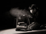 Girl child discovering hidden books in attic Stock Images