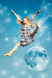 Girl jumping over the moon Royalty Free Stock Photos