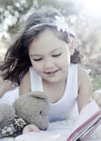 Cute girl reading book Royalty Free Stock Photography