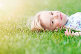 Girl lying in grass Royalty Free Stock Images