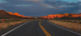Sunset over a desert road Stock Photo