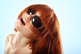 Summer teen girl redheaded in sunglasses over blue Royalty Free Stock Photography
