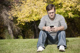 Young Adult Using His Smart Phone Royalty Free Stock Images