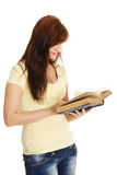 Young caucasian girl reading a book. Stock Images