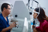 Eyesight exam with Asian doctor and patient Royalty Free Stock Photography