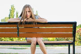 Sad teenager on park bench Royalty Free Stock Image