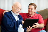 Teaching Dad to Use Tablet PC Stock Images