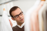 Adult man choosing shirt in clothes shop Royalty Free Stock Photos