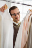 Adult man choosing shirt in clothes shop Royalty Free Stock Images