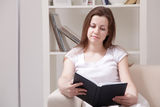 Girl read book at home Royalty Free Stock Image