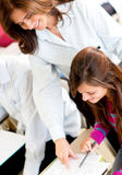Teacher explaining to a female student Stock Image