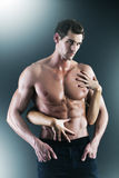 Sexy muscular naked man and female hands Royalty Free Stock Photography