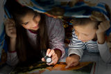 Children reading at night Stock Photo