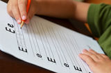 Education Concept With Child Learning To Write Stock Photo