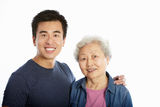 Studio Portrait Of Chinese Mother With Adult Son Stock Photo