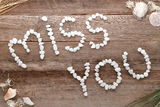 Miss You Love Words Written in Pebbles on Old Wood Stock Image