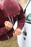 Youth breaking into a car Royalty Free Stock Photography