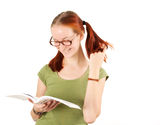 Young girl wearing glasses holding textbook. Royalty Free Stock Photos