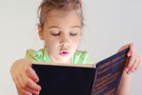 Little blue eyes girl read blue book Royalty Free Stock Image