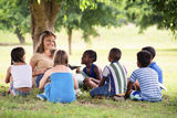 Teacher reading book to elementary students Stock Image