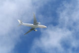 White Airplane over clouds Royalty Free Stock Photo