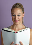 Vertical portrait of a woman reading textbook Stock Photo