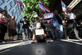 Anti government white mask protest in bangkok a disabled protester wearing a guy fawkes leads an rally through s shopping district Royalty Free Stock Photography